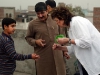 Carolyn learns the intricacies of kite flying on a rooftop in Lahore, Pakistan.